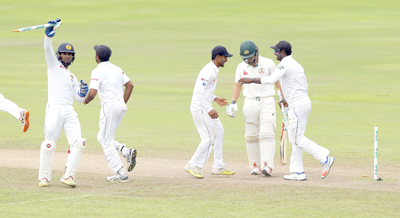 Sri Lankan team members from left to right Dinesh Chandimal Dilruwan Perera Dhananjaya de Silva and Angelo Mathews celebrate their teams&#039 victory over Australia by 106 runs as Steve O&#039 Keefe leaves the field on day five of their first test