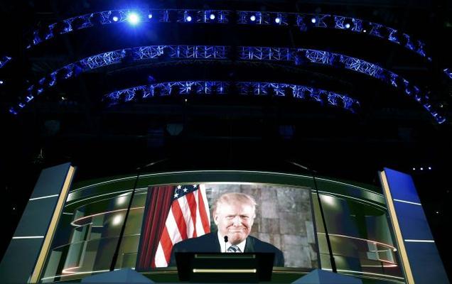 Republican presidential nominee Donald Trump appears on a video screen at the Republican National Convention in Cleveland Ohio US