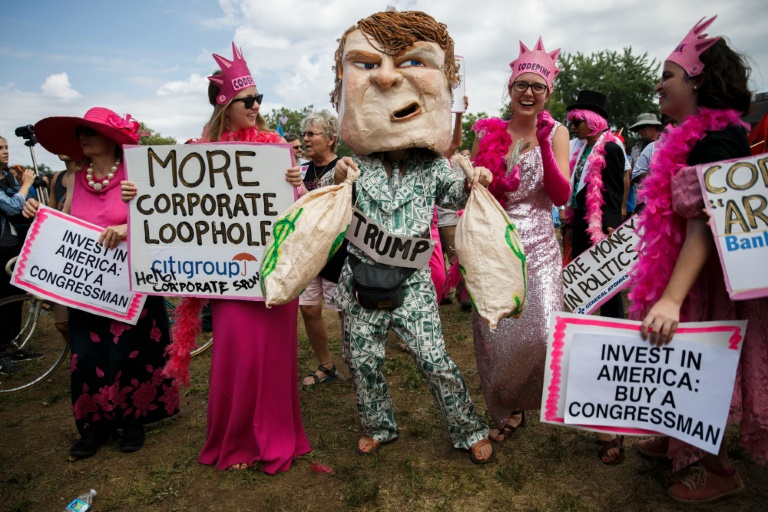 Activists with Code Pink protest presumptive Republican presidential candidate Donald Trump and corporations before a Prophets of Rage pop-up concert at the 2016 Republican National Convention in Cleveland Ohio on July 18