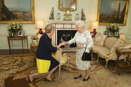 Britain's Queen Elizabeth welcomes Theresa May at the start of an audience in Buckingham Palace where she invited her to become Prime Minister in Lond