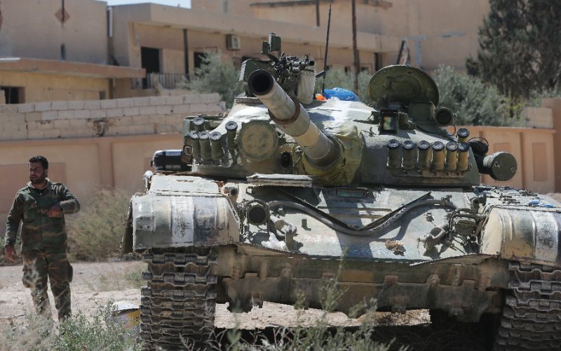 Syrian soldiers patrol in the town of al-Qaryatain in the province of Homs