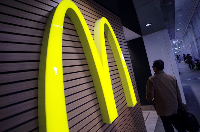 ASSOCIATED PRESS           A man walked by a McDonald’s restaurant in Tokyo in Dec. 2014. It was announced today that McDonald’s is the first company to partner with the wildly popular smartphone game “Pokemon Go.” The compan