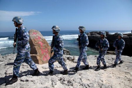 Soldiers of China's People's Liberation Army Navy patrol at Woody Island in the Paracel Archipelago which is known in China as the Xisha Islands