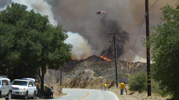 The Latest: Weather aids firefighters on California coast