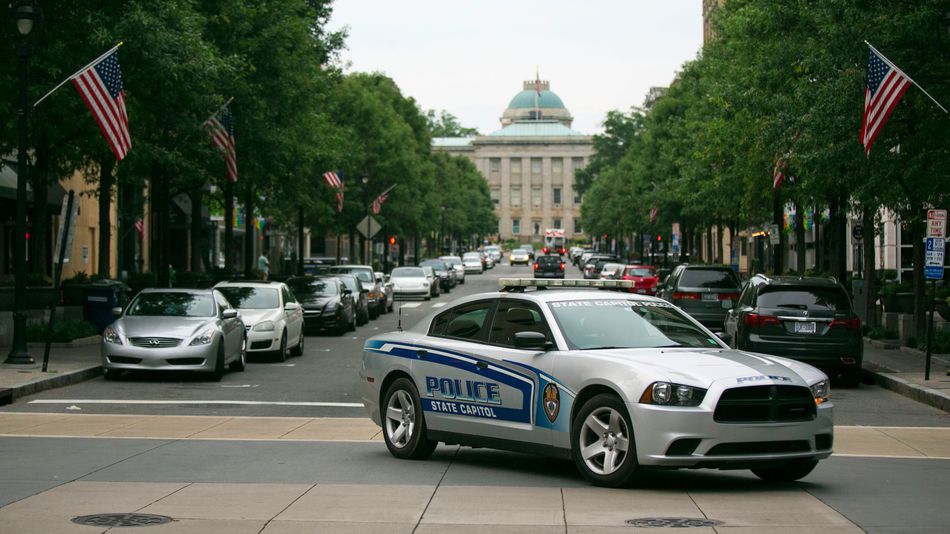 A State Capitol Police car drives near the North Carolina State Capitol