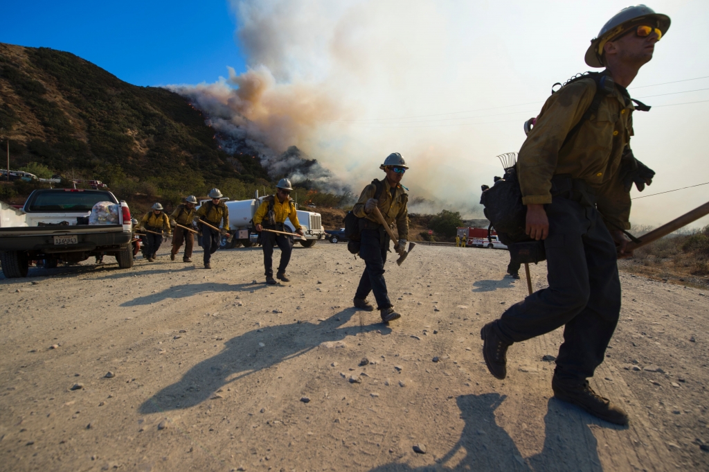 A hand crew prepares to clear a hot spot at the Blue Cut Fire near Wrightwood California