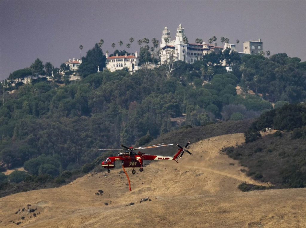 Image A helicopter flies past Hearst Castle