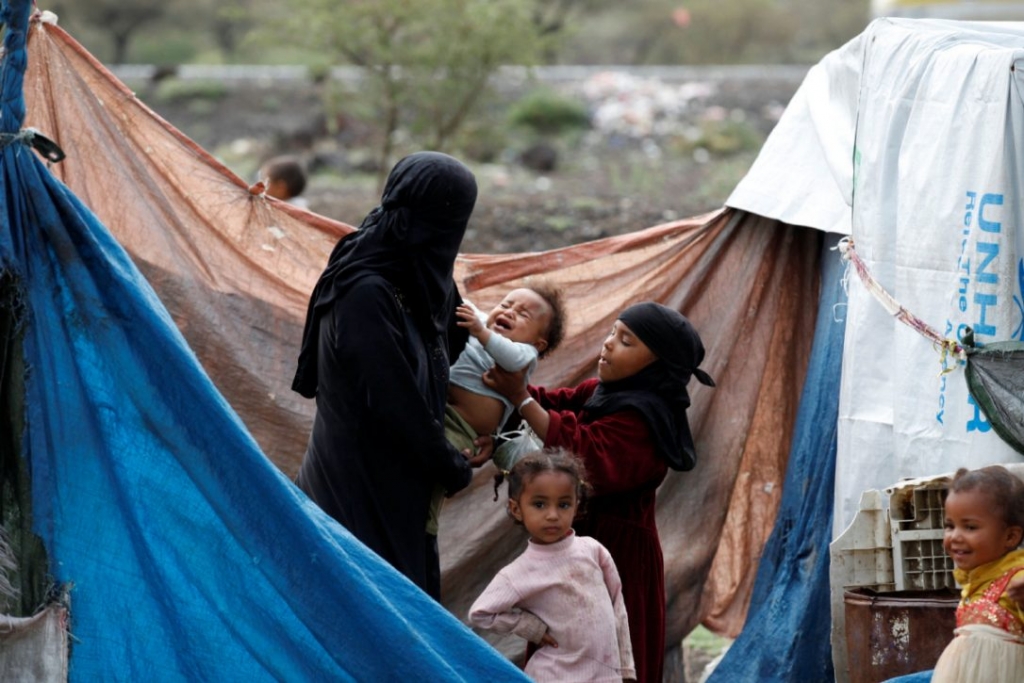 A woman and her children stand near their tent at a camp for internally displaced people near Sanaa Yemen on Monday. An airstrike hit a hospital supported by Doctors Without Borders in northern Yemen on Monday killing and wounding an unknown number of