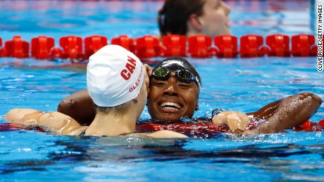 American Simone Manuel hugs Penny Oleksiak of Canada after the two tied in the women's 100m freestyle to win the gold medal