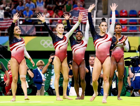 Laurie Hernandez Madison Kocian Simone Biles Alexandra Raisman and Gabrielle Douglas of the United States celebrate winning the gold medal during the Artistic Gymnastics Women's Team Final on Day 4 of the Rio 2016 Olympic Games at the Rio Olympic Arena