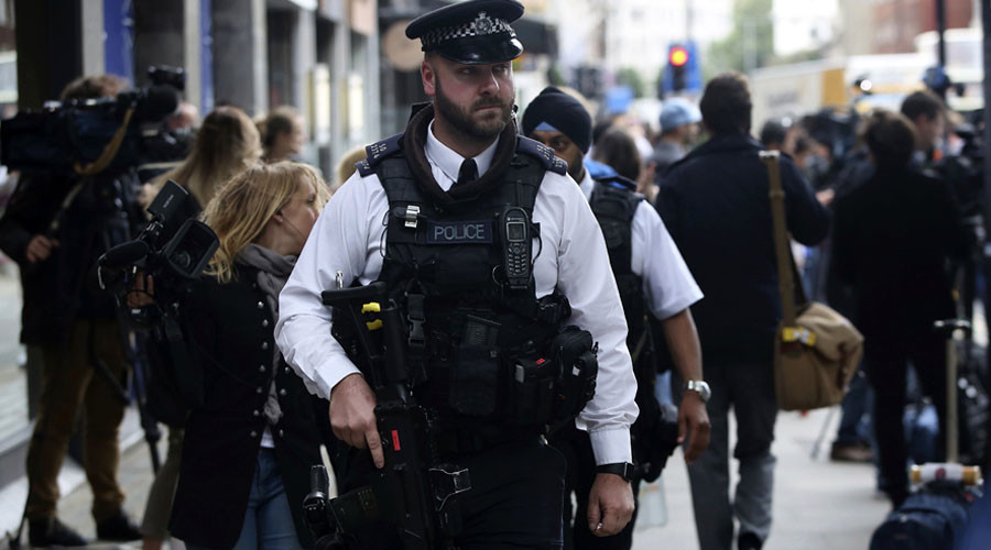 Armed police officers patrol at the scene of a knife attack in Russell Square in London Britain