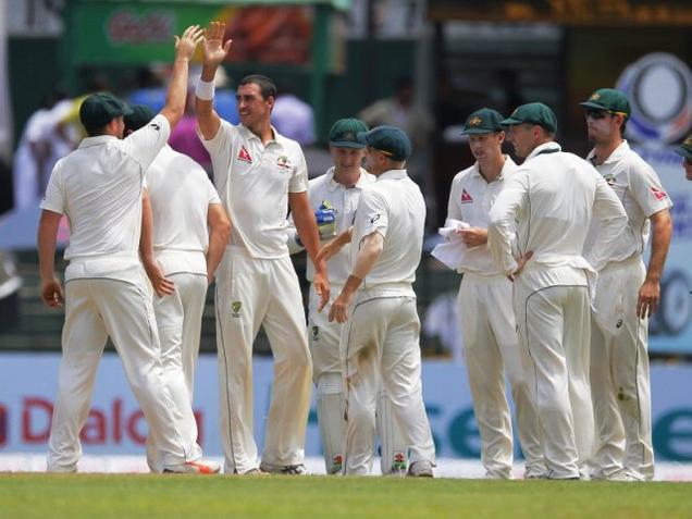 Australia's Mitchell Starc celebrates with teammates after a Sri Lankan wicket during the first day of the third Test in Colombo on Saturday