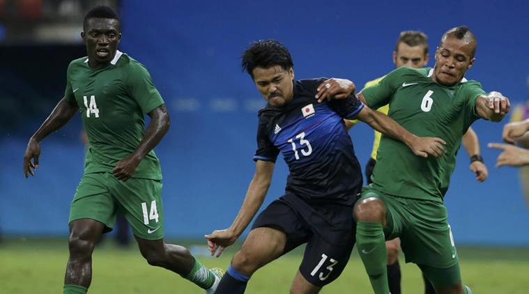 2016 Rio Olympics- Soccer- Preliminary- Men's First Round- Group B Nigeria v Japan- Amazonia Stadium- Manaus Brazil- 04/08/2016. William Troost Ekong of Nigeria and Shinzo Koroki of Japan in action. REUTERS  Bruno Kelly  FOR