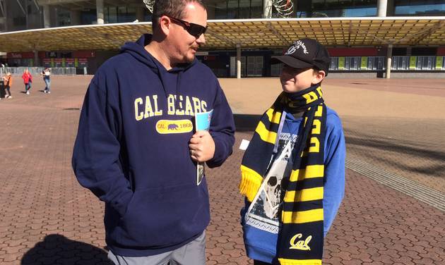 Anthony Goodluck left and his son Jaiden outside the Sydney Olympic stadium ahead of the opening U.S. college football game of the season between the Hawaii Rainbow Warriors and the California Golden Bears Saturday Aug. 27 2016. (AP