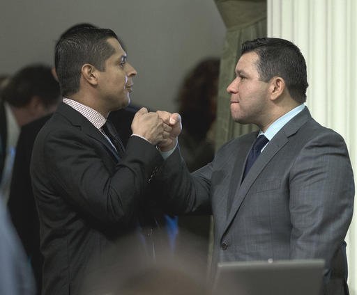 Assemblyman Eduardo Garcia D-Coachella right receives congratulations from Assemblyman Miguel Santiago D Los Angeles after his measure to give lawmakers more oversight over the state's efforts to combat global warming was approved by the Assembly Wed