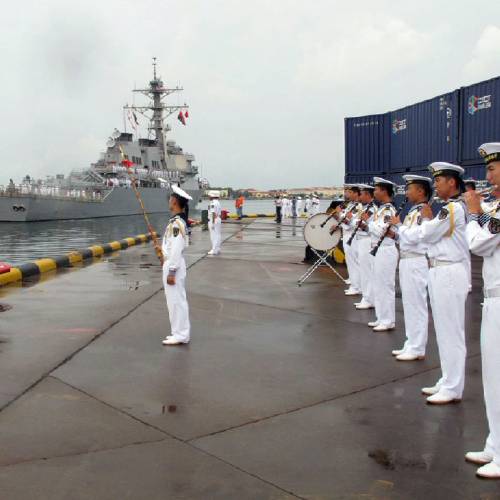 Chinese military band plays as the guided missile destroyer USS Benfold arrives in port in Qingdao in eastern China's Shandong Province. The visit of the U.S. Navy's USS Benfold to the