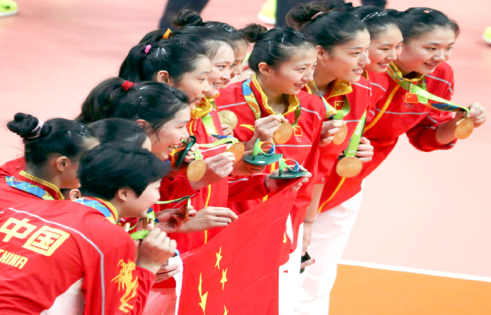 China's players pose with their volleyball gold medals in Rio Saturday. — Reuters