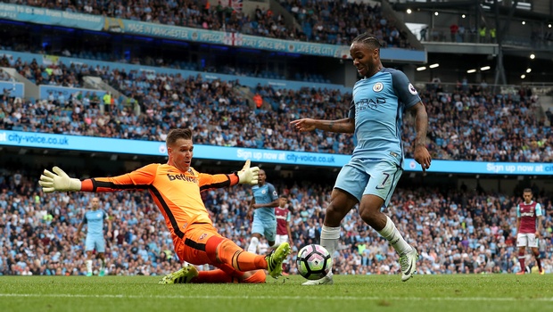 Manchester City's Raheem Sterling right goes past West Ham United goalkeeper Adrian before scoring his side's third goal during the Premier League match Manchester City versus West Ham United at the Etihad Stadium Manchester England. | AP