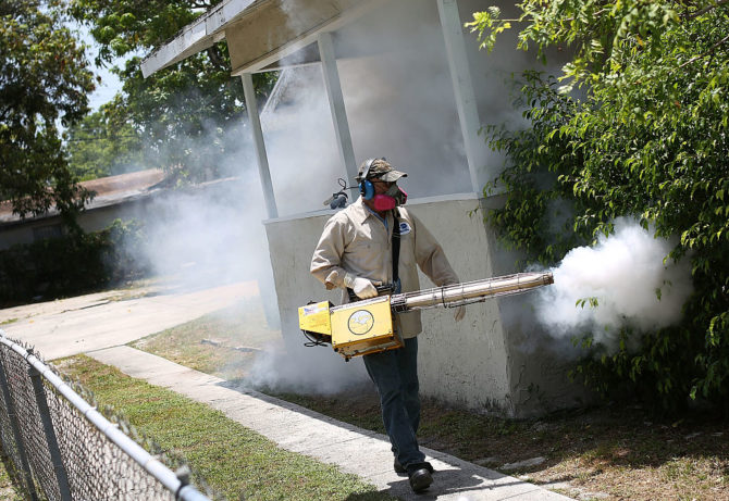 County mosquito control inspector uses a Golden Eagle blower to spray pesticide to kill mosquitos