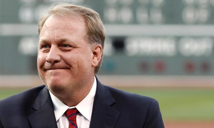 Former Boston Red Sox pitcher Curt Schilling looks on after being introduced as a new member of the Boston Red Sox Hall of Fame before the baseball game between the Boston Red Sox and the Minnesota Twins at Fenway Park in Boston Friday Aug. 3 2012. (AP