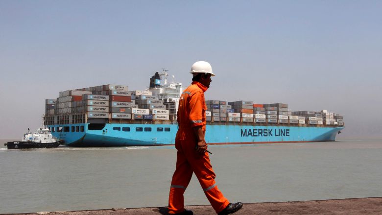 A worker walks past a container ship at Mundra Port in the western Indian state of Gujarat. Nearly 10,000 Indian workers laid off of their jobs in Saudi Arabia were stranded without enough money for food. REUTERS  Amit Dave  File