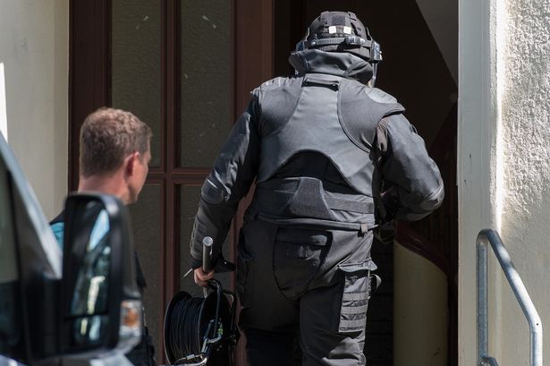 A Brandenburg SWAT team member enters a house during an operation to arrest a 27-year-old in Eisenhuettenstadt