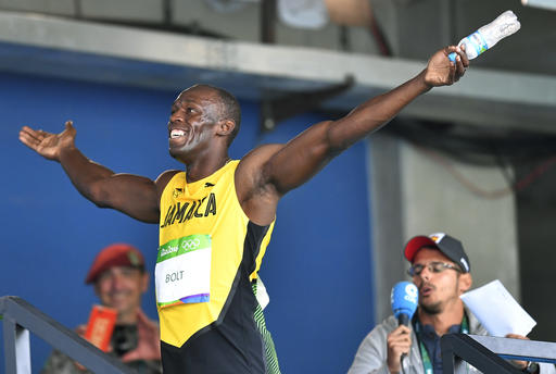 Jamaica's Usain Bolt celebrates after winning a men's 100-meter heat during the athletics competitions of the 2016 Summer Olympics at the Olympic stadium in Rio de Janeiro Brazil Saturday Aug. 13 2016