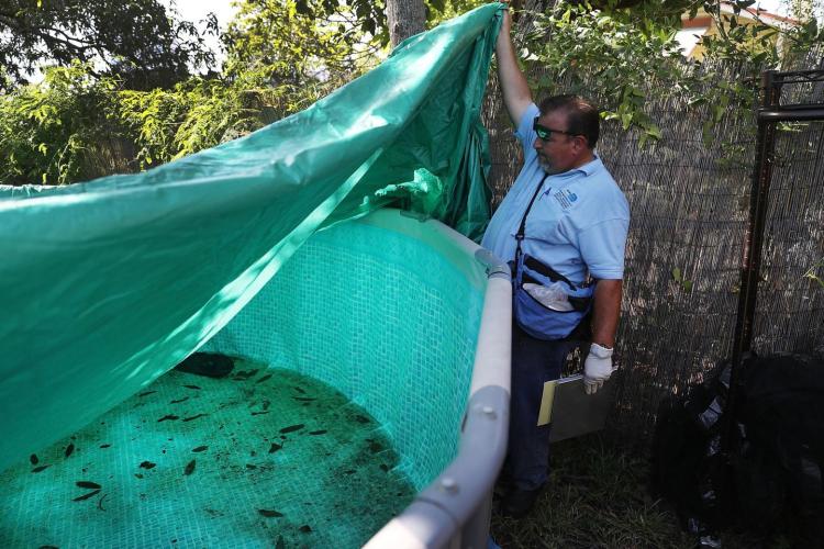 Robert Muxo a Miami Dade County mosquito control inspector inspects a property for mosquitos or breeding areas in the Wynwood neighborhood