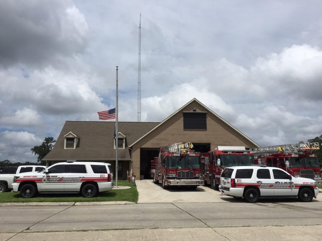 Flags fly at half staff at the St. John the Baptist Fire Station in honor of Chief Spencer Chauvin