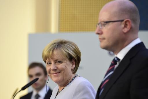 German Chancellor Angela Merkel left smiles during a joint press conference with Czech Prime Minister Bohuslav Sobotka right in Prague Czech Republic Thursday Aug. 25 2016