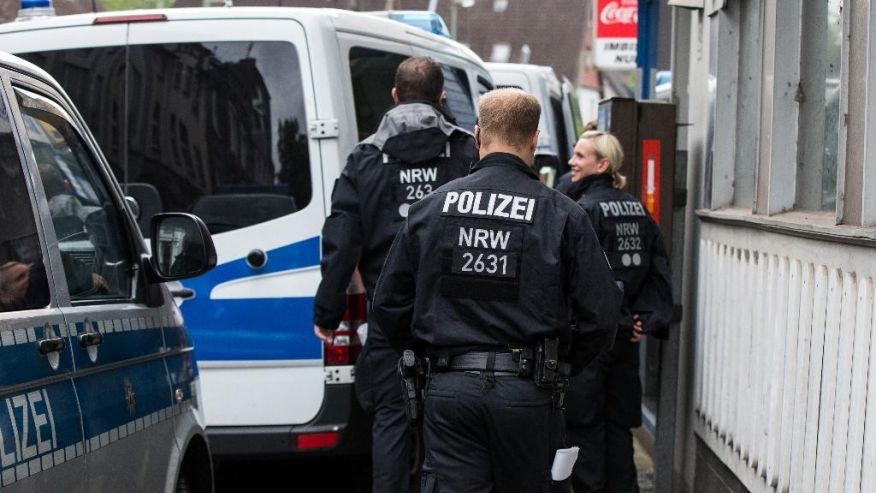 German police guards in front of a Turkish travel agency in Duisburg Germany Wednesday Aug. 10 2016. German prosecutors say they've carried out searches linked to three suspected supporters of the Islamic State group. The federal prosecutor&#x27