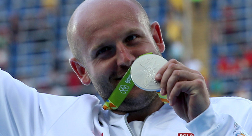 Piotr Malachowski of Poland poses with his silver medal