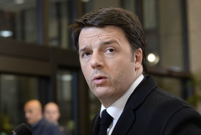 Italian Prime Minister Matteo Renzi speaks to journalists as he leaves at the end of an European Council leaders summit at the European Union Headquarters in Brussels