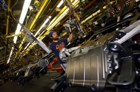 Jacob Bailey conducts assembly work on an SUV chassis at the General Motors Assembly Plant in Arlington Texas