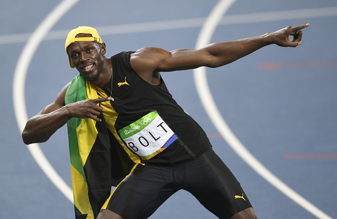 Jamaica’s Usain Bolt celebrates winning the men’s 100-meter track final at the Rio Olympics Sunday Aug. 14