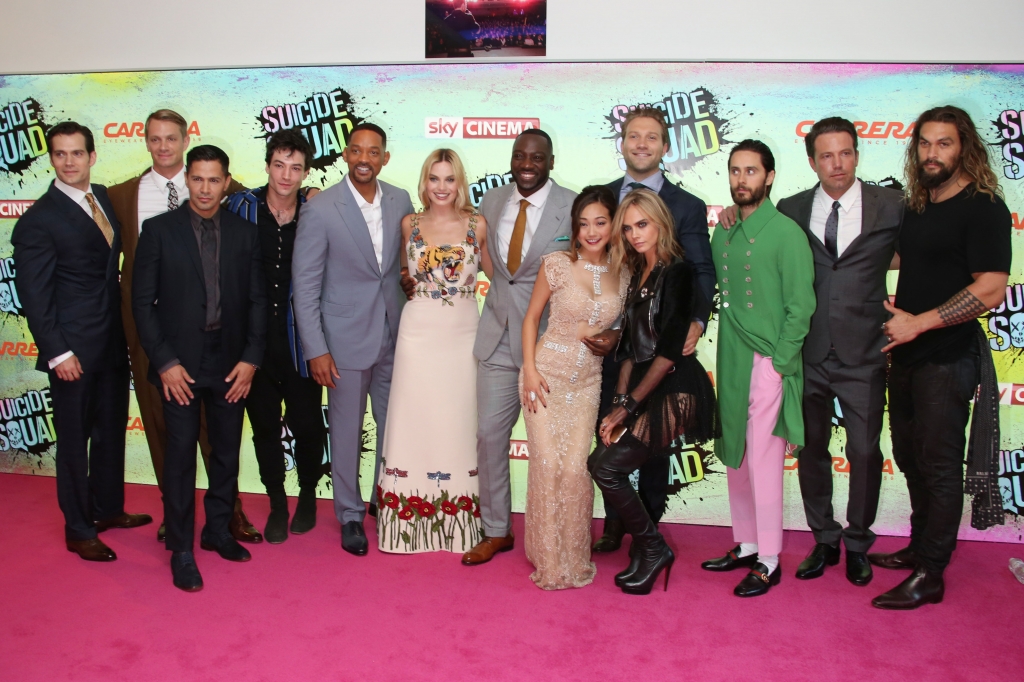 Actors from left to right Henry Cavill Joel Kinnaman Jay Hernandez Ezra Matthew Miller Will Smith Margot Robbie Adewale Akinnuoye Karen Fukuhara Jai Courtney Cara Delevingne Jared Leto Ben Affleck and Jason Momoa pose for