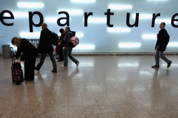 Jeff J Mitchell  Getty Images

People pass through Glasgow International Airport check