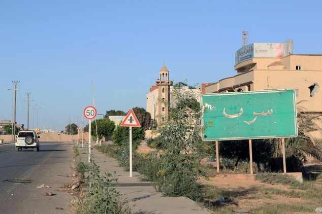 A general view shows a sign reading in Arabic'Sirte as fighters from the pro-government forces loyal to Libya's Government of National Unity prepare