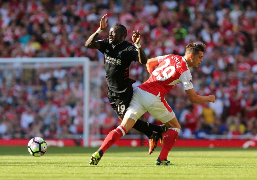 Arsenal's Swiss midfielder Granit Xhaka right challenges Liverpool's Senegalese midfielder Sadio Mane during August 14 English Premier League play. Liverpool came from behind to win the match 4-3