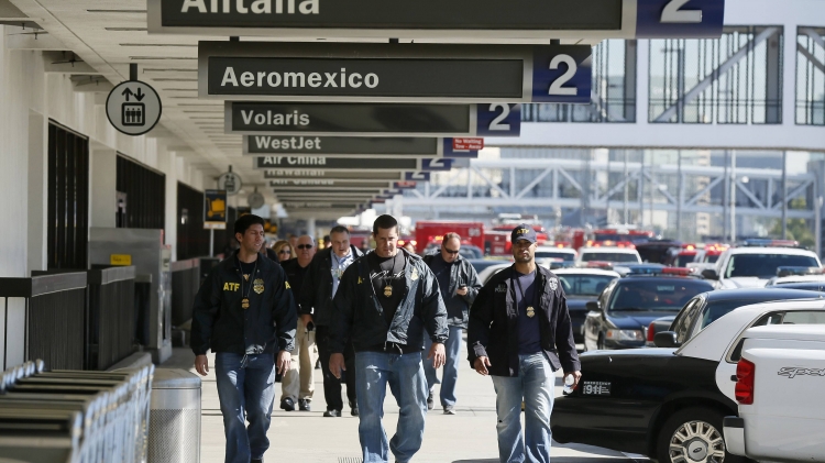 Alcohol Tobacco Firearms and Explosives officers walk outside terminal 2 after a shooting incident at Los Angeles airport, California