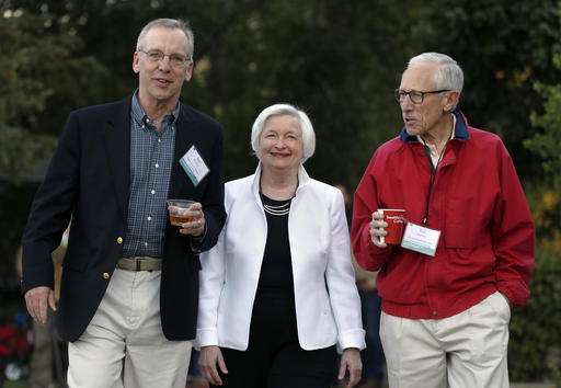 Federal Reserve Chair Janet Yellen center strolls with Stanley Fischer right vice chairman of the Board of Governors of the Federal Reserve System and Bill Dudley the president of the Federal Reserve Bank of New York before her speech to the annual