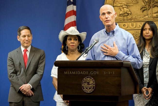 Florida Gov. Rick Scott foreground speaks during a news conference along with Centers for Disease Control and Prevention Director Dr. Tom Frieden left Rep. Frederica Wilson D-FL and Fla. Surgeon General and Se