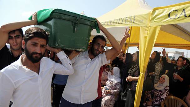 Mourners carry a victim's coffin as they attend funeral services for dozens of people killed in the bomb attack in Gaziantep