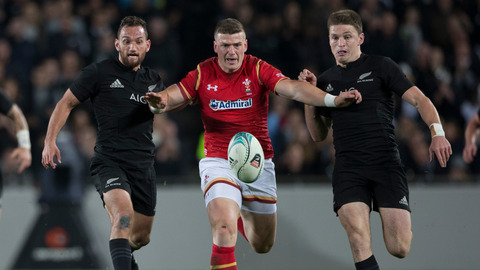 New Zealand All Blacks 1st-five Aaron Cruden and Beauden Barrett compete for the ball with Wales centre Jonathan Davies