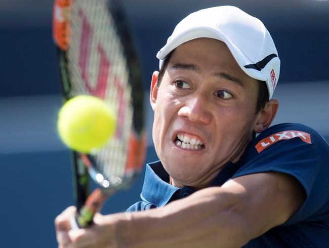 Kei Nishikori of Japan returns the ball to Stanislas Wawrinka of Switzerland during men's semifinal Rogers Cup tennis action in Toronto on Saturday