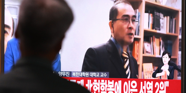 A man watches TV news airing a file image of Thae Yong Ho minister at the North Korean Embassy in London at Seoul Railway Station in Seoul South Korea