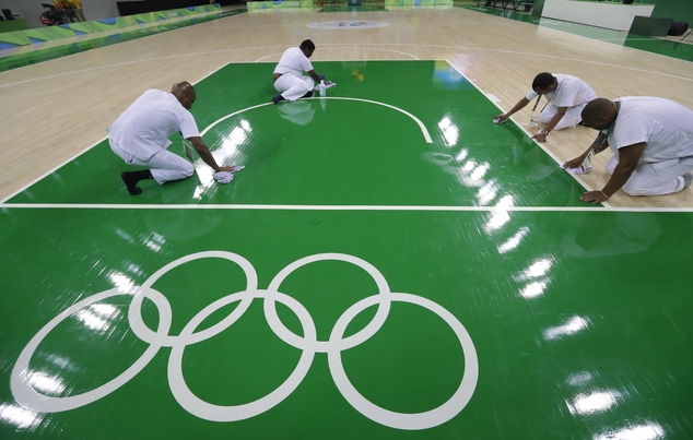 Work crews clean the basketball floor during an off day for women's basketball at the Youth Center at the 2016 Summer Olympics in Rio de Janeiro Brazil Fri