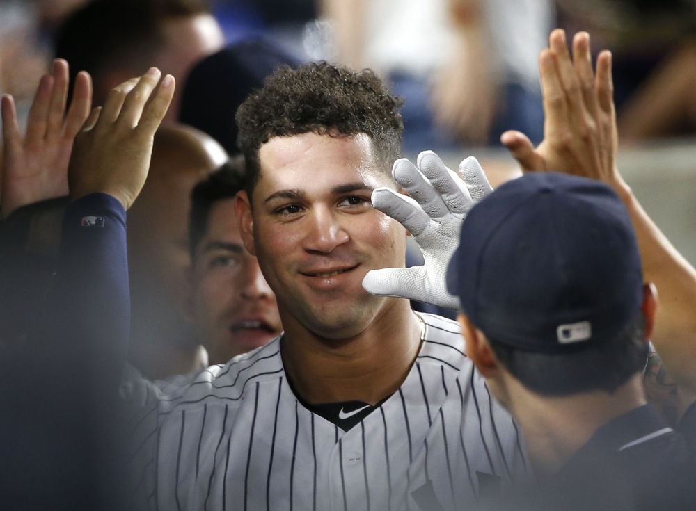 Teammates celebrate with New York Yankees Gary Sanchez center and Jacoby Ellsbury left after Sanchez hit a fifth-inning two-run home run scoring Ellsbury in a baseball game against the Baltimore Orioles in New York Friday Aug. 26 2016. (AP Phot