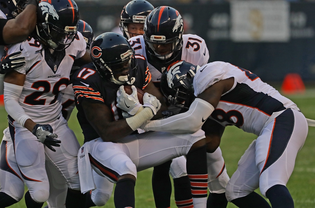 CHICAGO IL- AUGUST 11 Alshon Jeffery #17 of the Chicago Bears is gang-tackled by Bradley Roby #29 Justin Simmons #31 and Shaquil Barrett #48 of the Denver Broncos at Soldier Field