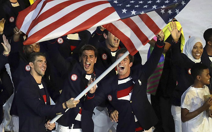 Michael Phelps carries the flag of the United States during the opening ceremony for the 2016 Summer Olympics in Rio de Janeiro Brazil Friday Aug. 5 2016